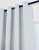 Close-up view of light gray blackout curtains hanging from a black curtain rod. Produktbild-Vorschau