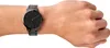 A close-up shot of a black watch on a person's wrist. Anteprima dell’immagine prodotto