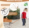 A young child is pulling a wooden wagon outdoors on a paved patio. Voir les images du produit