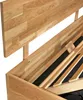 A close-up view of a wooden bed frame, showing the headboard and the slatted base. Produktbild-Vorschau