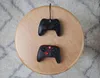 Two Nintendo Switch controllers are placed on a round wooden table. Anteprima dell’immagine prodotto