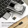 A digital camera, battery, and memory card are placed on a laptop keyboard and a wooden surface. Produktbild-Vorschau