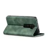 A green flip case for a smartphone is shown from the back, propped open. Produktbild-Vorschau