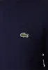 A close-up shot of a navy blue sweatshirt with a small green crocodile logo. Anteprima dell’immagine prodotto