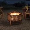 A fire pit is lit and burning in a backyard setting at dusk, with chairs and a side table nearby. Produktbild-Vorschau