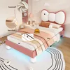 A child's bed with a bow-shaped headboard in a bedroom setting. Anteprima dell’immagine prodotto