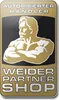 A golden badge with a silhouette of a muscular man and text indicating an authorized dealer and partner shop. Produktbild-Vorschau