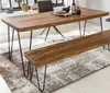 A wooden dining table and bench set with metal legs, placed on a rug in a room with natural light. Anteprima dell’immagine prodotto