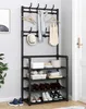 A black metal coat rack and shoe rack with various items on it, placed in a hallway next to a door. Náhled obrázku produktu
