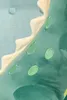 A close-up of a green plush dinosaur toy with cream-colored spikes along its back. Produktbild-Vorschau