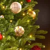 A close-up view of a decorated Christmas tree with ornaments and lights. Produktbild-Vorschau