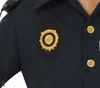 Close-up of a police uniform badge on a dark blue shirt. Produktbild-Vorschau