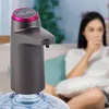 A woman drinks water from a glass while a water bottle pump is attached to a water bottle in the foreground. Náhled obrázku produktu