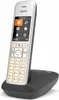 A cordless phone and its charging base are shown against a white background. Podgląd zdjęcia produktu