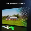 A screen displaying a farm scene with horses and a barn, with a digital effect breaking apart the right side of the image. The text '4K 8MP Ultra HD' is displayed at the top, and a large '4K' logo is at the bottom. Produktbild-Vorschau