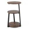 A three-tiered round side table with a rustic brown wood-look finish and black metal legs, presented against a white background. Voir les images du produit
