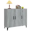 A gray wooden sideboard with three doors and black legs, shown against a white background. A lamp, a radio, and an apple are placed on top of the sideboard. Produktbild-Vorschau