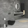 A modern, minimalist bathroom with a matte black wall-hung toilet, a vanity with a black sink, and a black radiator. Podgląd zdjęcia produktu