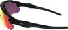 A pair of Oakley sunglasses with red and yellow lenses and black frames, shown from a side angle against a white background. Náhled obrázku produktu