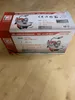 The image shows the packaging of a Holzmann DKS21Pro scroll saw, with product specifications and images of the saw printed on the box. Voir les images du produit