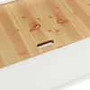 A close-up view of the lid of a wooden bench with a white base. Náhled obrázku produktu