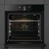 An open oven with racks and a baking tray inside. Produktbild-Vorschau