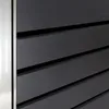 A close-up view of a dark grey slatted surface with a silver edge, likely part of a trash can enclosure. Produktbild-Vorschau