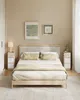 A bedroom scene featuring a bed with nightstands. Náhled obrázku produktu