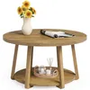 A round wooden coffee table with a vase of sunflowers and a magazine on top, and a tray with decorative items on the lower shelf. Produktbild-Vorschau
