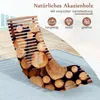 A lounge chair made of acacia wood is shown with a background of stacked logs and a wooden deck. Náhled obrázku produktu