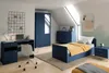 A bedroom with a navy blue wardrobe, desk, chair, and bed with yellow bedding. Podgląd zdjęcia produktu