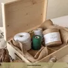 A wooden box filled with spools of twine and burlap fabric. Produktbild-Vorschau