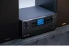 A black Kenwood stereo system with speakers on a dark patterned surface. Anteprima dell’immagine prodotto