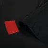 A roll of black tinting film and a red squeegee are shown on a black reflective surface. Podgląd zdjęcia produktu