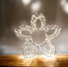 A decorative LED flower light on a wooden surface. Produktbild-Vorschau