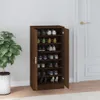A shoe cabinet filled with shoes, placed in a room next to a plant. Náhled obrázku produktu