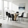 A dining set with a table and four chairs in a modern dining room with large windows. Produktbild-Vorschau
