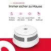 A white smoke detector is shown in the foreground against a white and red background. Text and icons describing its features are displayed above the product. Produktbild-Vorschau