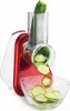 A red and white electric vegetable slicer is shown in use, slicing a zucchini into thin rounds that fall into a clear glass bowl. Náhled obrázku produktu