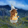 A plush marmot toy dressed in traditional Bavarian attire, standing in a mountainous landscape with waterfalls. Produktbild-Vorschau