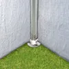 Close-up of the base of a tent pole on grass, showing the anchoring mechanism. Produktbild-Vorschau