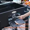 A person is adding charcoal to a black grill. Anteprima dell’immagine prodotto