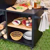 An outdoor cooking setup with a black serving cart, wood logs, and various cooking ingredients. Produktbild-Vorschau