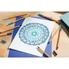 A mandala drawing with several pens scattered around it on a wooden surface. Produktbild-Vorschau