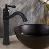 A black faucet is shown above a black sink, with a stone-like wall in the background. Náhled obrázku produktu