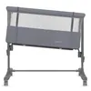 A gray baby crib/bassinet with mesh sides, shown at an angle on a white background. Anteprima dell’immagine prodotto