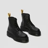 A pair of black Dr. Martens boots with platform soles are shown against a light gray background. Anteprima dell’immagine prodotto