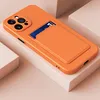 An orange phone case with a card slot is displayed on a light gray and white surface. Produktbild-Vorschau