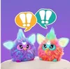 Two colorful, fluffy toy creatures with large eyes and ears are shown against a purple background. Above them are two speech bubbles with exclamation marks, suggesting communication or interaction. Náhľad obrázku produktu