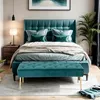 A bedroom scene with a teal upholstered bed and matching bench. Podgląd zdjęcia produktu